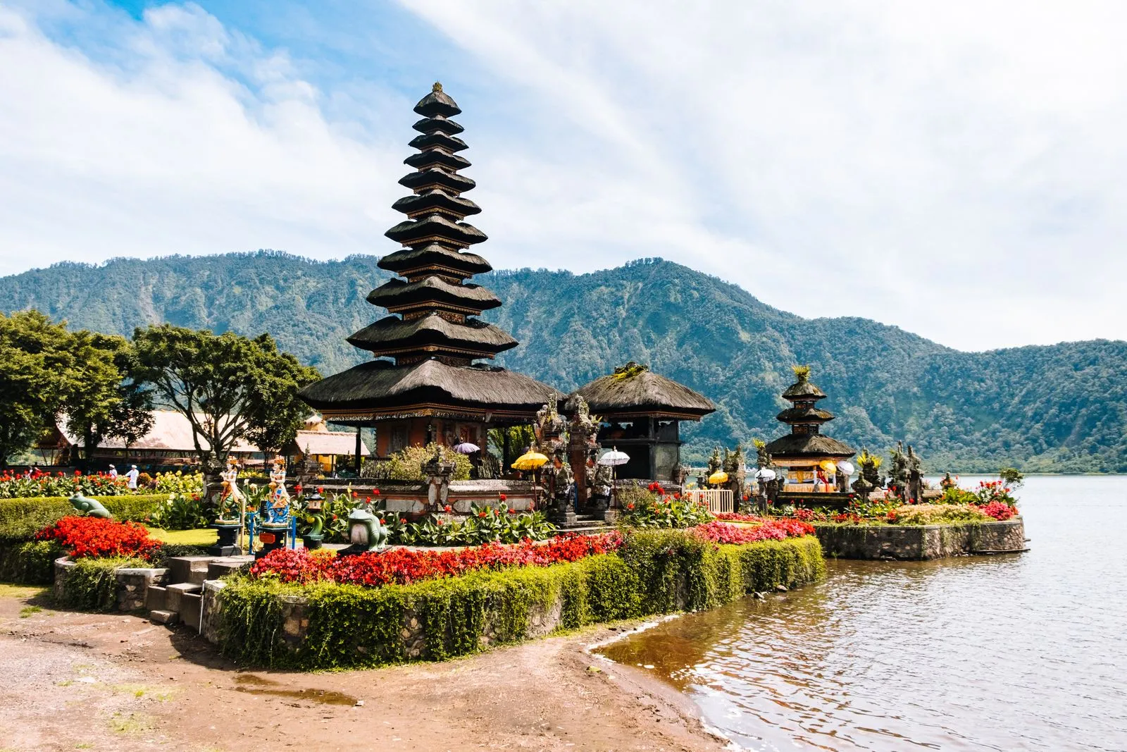 The tiered meru towers of a lake temple standing out over the water