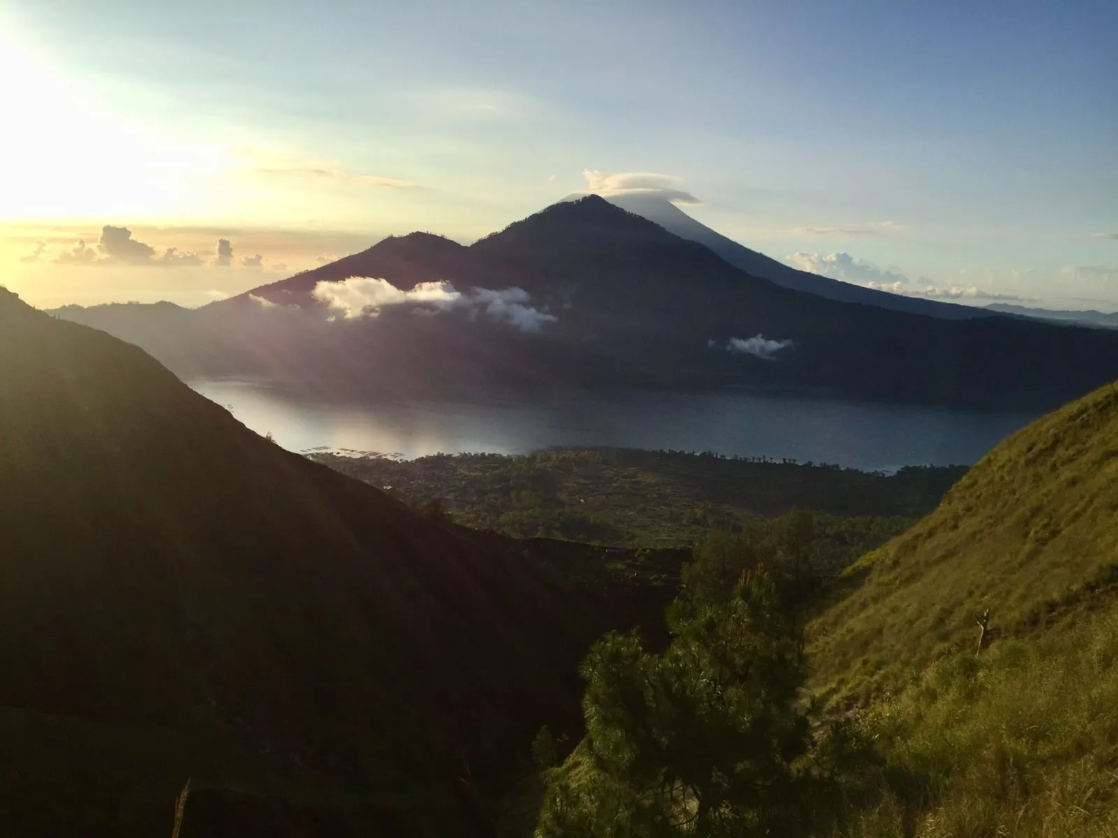 Mount Batur and its crater lake at sunrise from the Kintamani rim